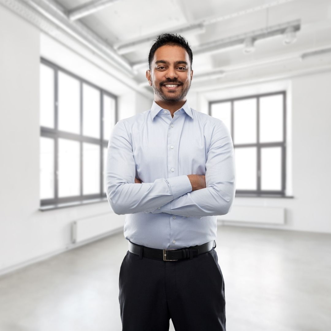 1080x1080-blitzimage4 man standing in commercial building