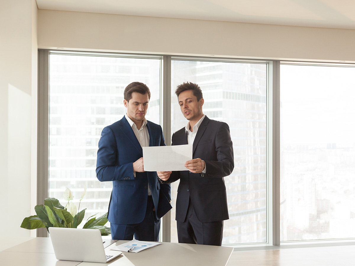 Image of two mean discussing a building plan