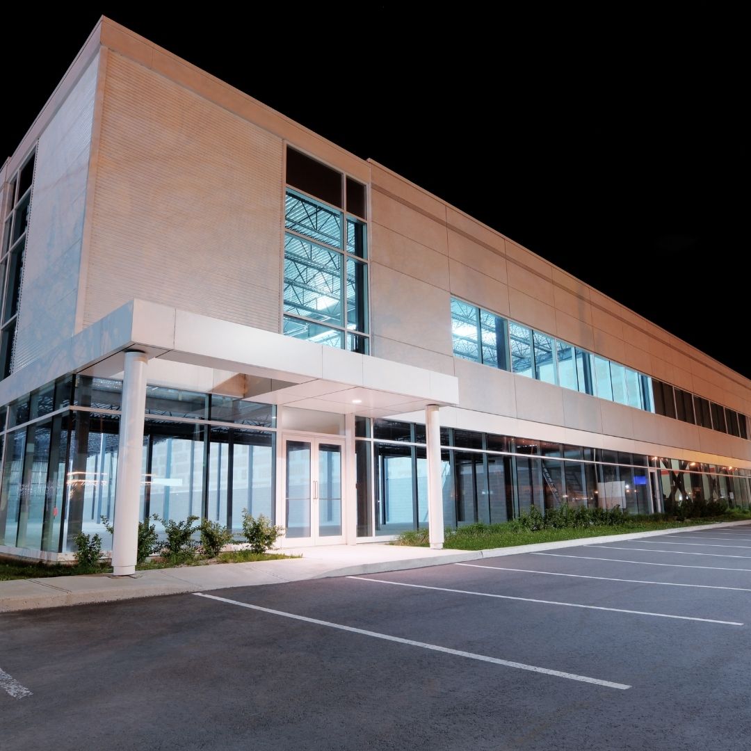 2 white commercial builidng lit up at night