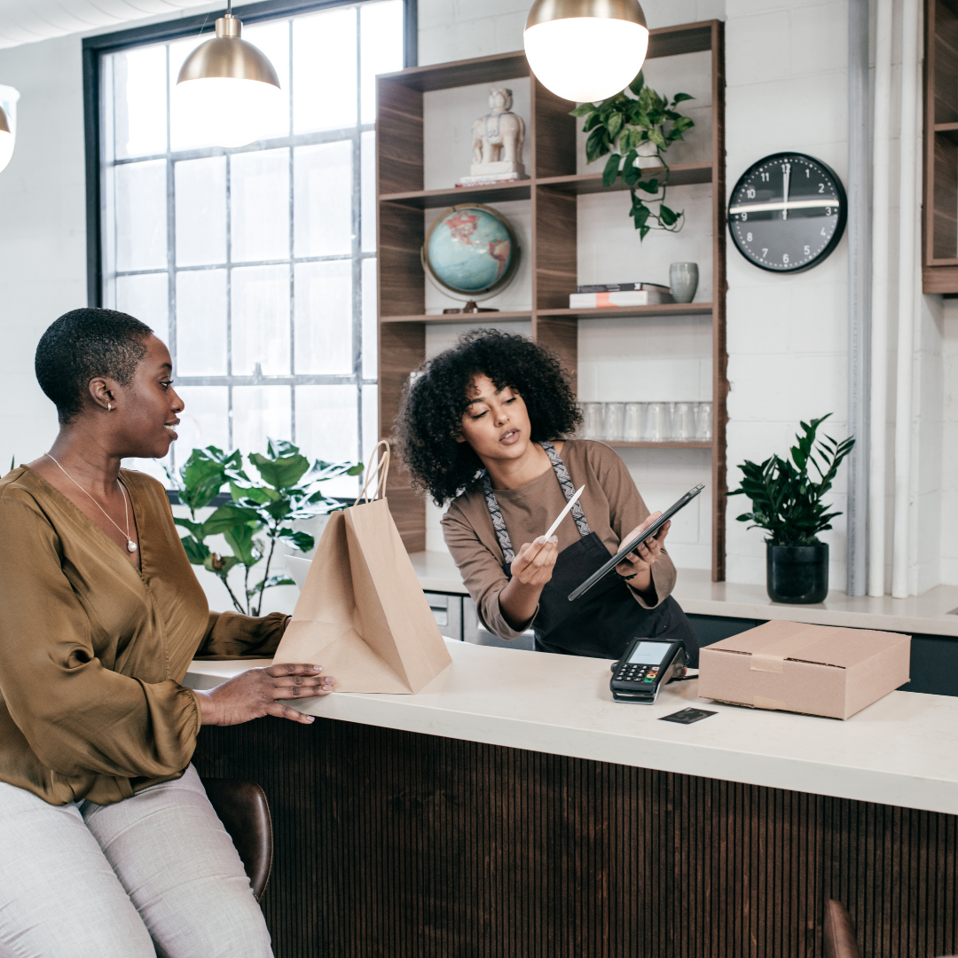 2 women at a business counter