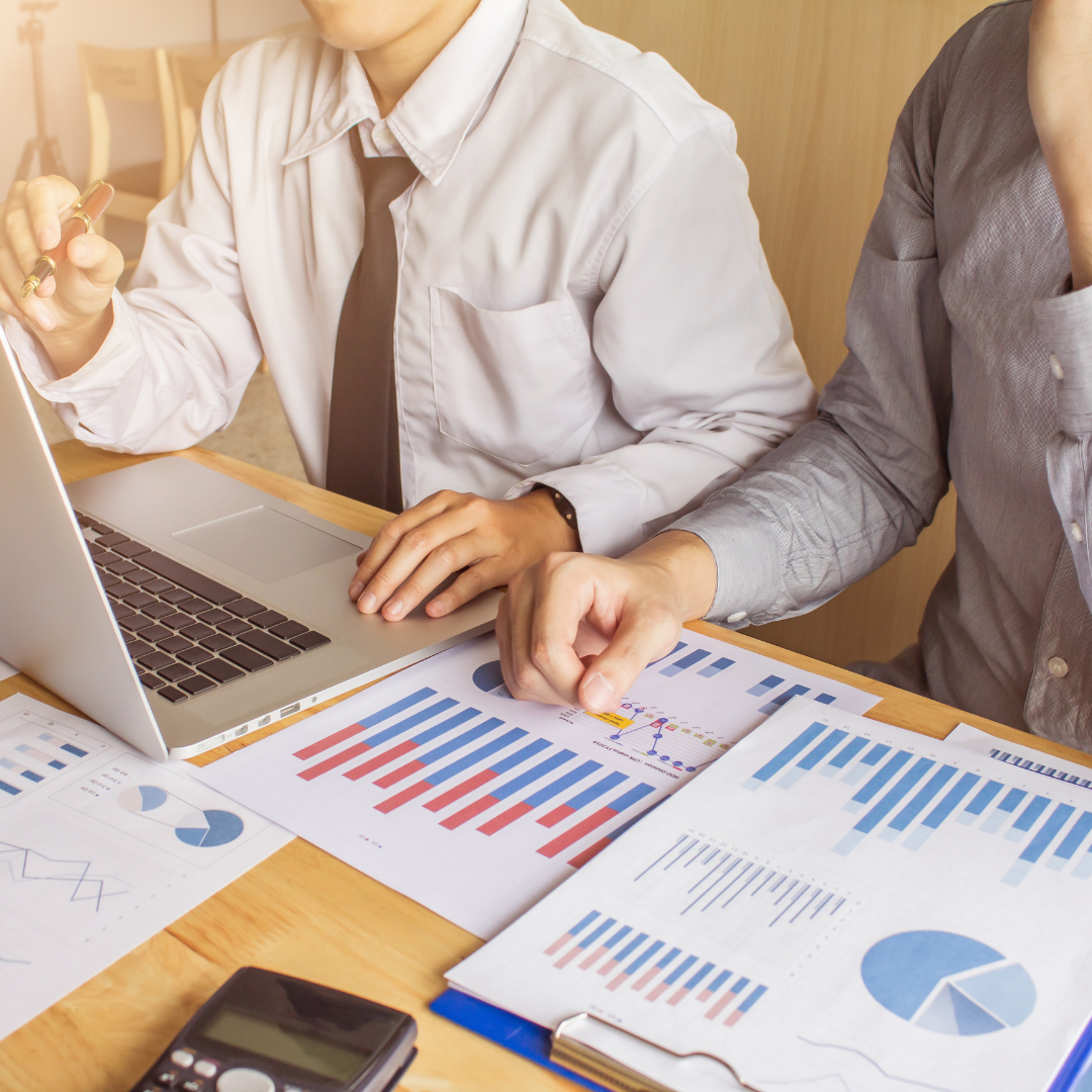 2 people at desk with business papers