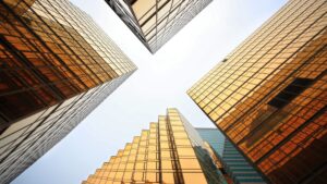 looking up at four large buildings whose corners almost meet